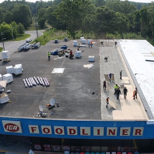 Roofers work on commercial roof.