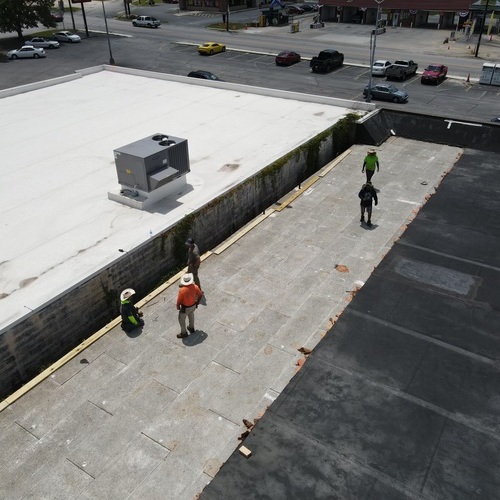 Roofers work on commercial roofer.